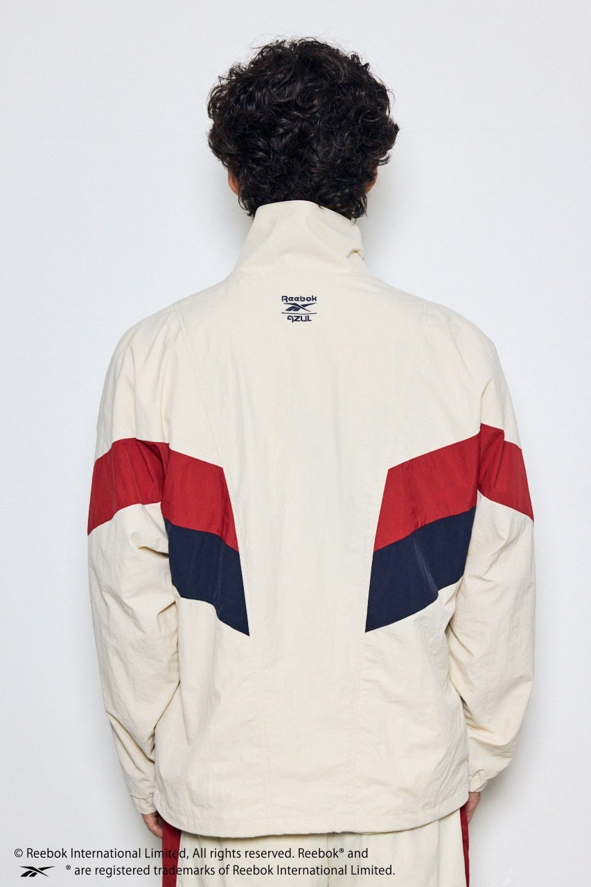 【REEBOK×AZUL】ナイロントラックジャケット IVOY M
