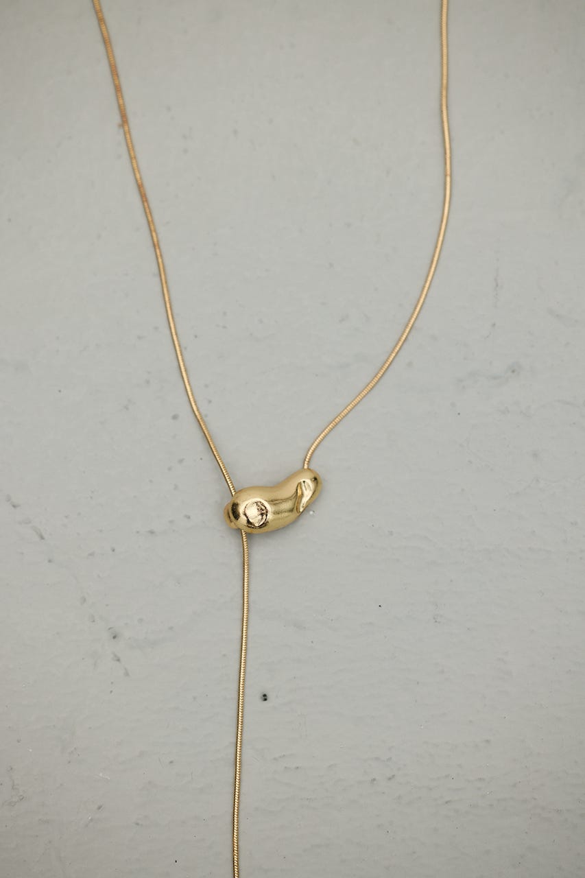 ニュアンスモチーフタイネックレス GLD FREE